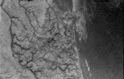 Titan&#039;s surface: lower areas are darker. Fluvial networks appear clearly; credits: Esa/Nasa/JPL/University of Arizona